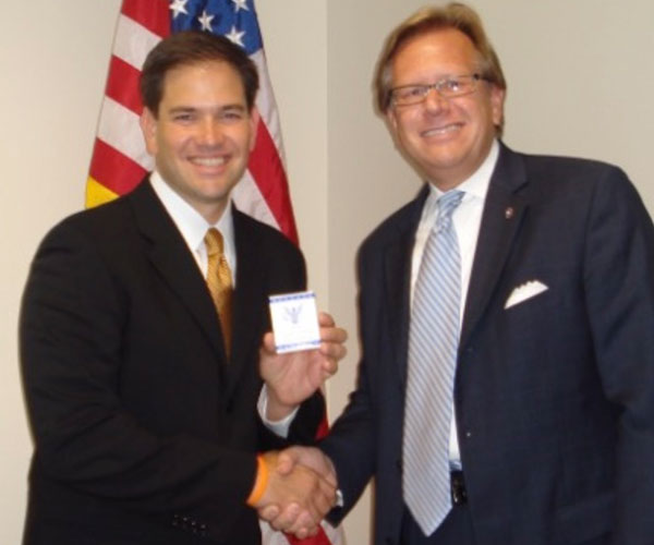 founder shaking hands with Marco Rubio