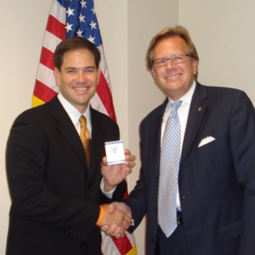 founder shaking hands with Marco Rubio